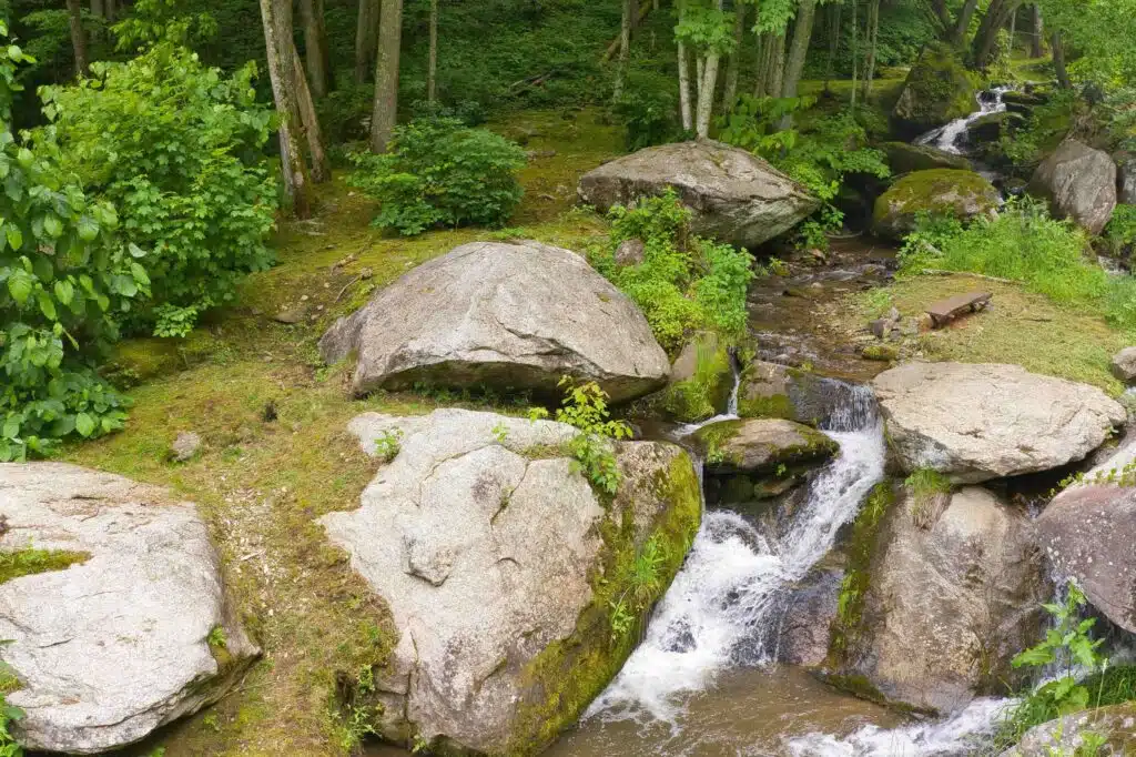 Dronephoto - flat rock to unicorn falls Private creek and waterfall landscape behind Windows Over Waterfalls cabin rental near Hot Springs, NC in the North Carolina mountains.
