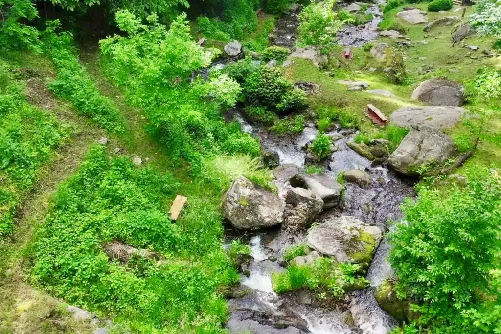 drone upper cascades looking straight downb Mountain vacation rental with waterfall sounds and mossy creekside landscape in North Carolina