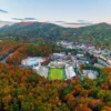 Fall in Boone NC — Linn Cove Viaduct on the Blue Ridge Parkway surrounded by crimson and gold fall foliage near Grandfather Mountain in October