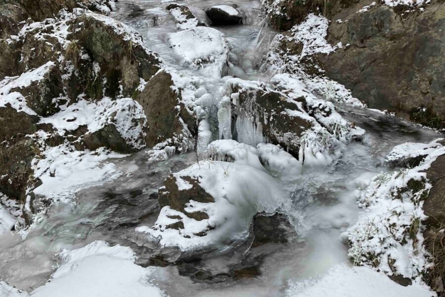 Private hot tub above the creek at Windows Over Waterfalls in winter, a quiet alternative to crowded Gatlinburg TN